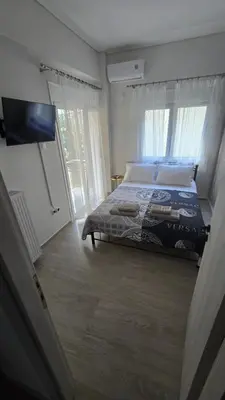 a bedroom with a bed and a tv in a room at Ovelix apartment in Athens