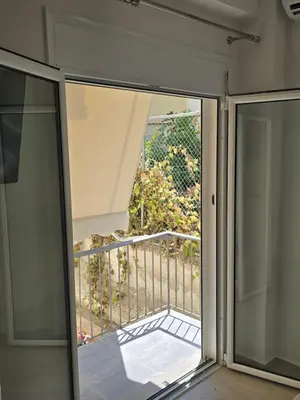 a sliding glass door with a view of a balcony at Ovelix apartment in Athens