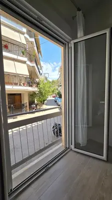 a sliding glass door with a view of a balcony at Ovelix apartment in Athens