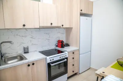 a kitchen with a sink and a stove top oven at Spacious 2 BR apartment next to Acropolis in Athens