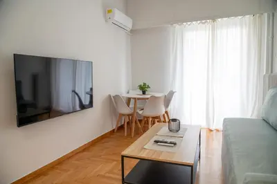 a living room with a couch and a table at Spacious 2 BR apartment next to Acropolis in Athens
