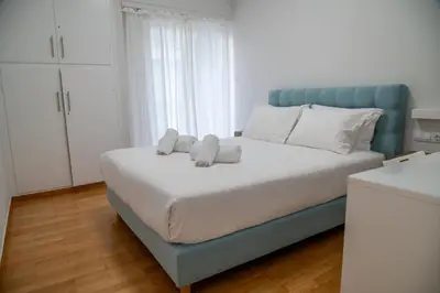 a bedroom with a bed with two towels on it at Spacious 2 BR apartment next to Acropolis in Athens