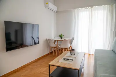 a living room with a couch and a table at Spacious 2 BR apartment next to Acropolis in Athens