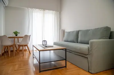 a living room with a couch and a table at Spacious 2 BR apartment next to Acropolis in Athens