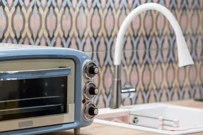 a toaster oven sitting on a counter next to a sink at Piraeus Marina Haven 1 in Piraeus