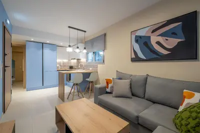 a living room and kitchen with a couch and a table at Piraeus Marina Haven 2 in Piraeus