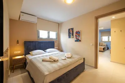 a bedroom with a bed with towels on it at Piraeus Marina Haven 2 in Piraeus