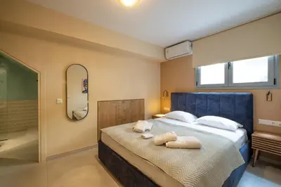 a bedroom with a bed with towels on it at Piraeus Marina Haven 2 in Piraeus