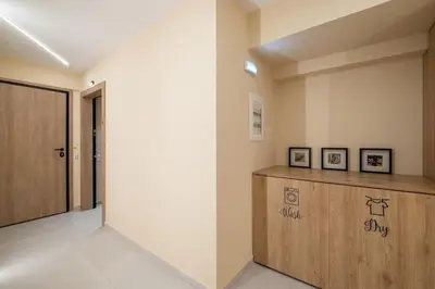 a hallway with a wooden cabinet and a door at Piraeus Marina Haven 2 in Piraeus