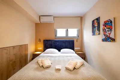 a bedroom with a bed with two pillows on it at Piraeus Marina Haven 2 in Piraeus