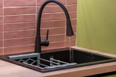 a kitchen sink with a faucet with water in it at Piraeus Marina Haven 3 in Piraeus