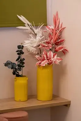 two yellow vases with flowers on a shelf at Piraeus Marina Haven 3 in Piraeus