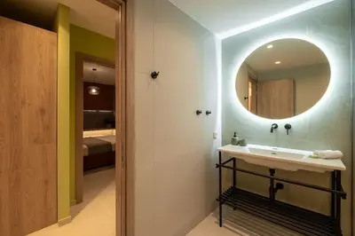 a bathroom with a sink and a mirror at Piraeus Marina Haven 3 in Piraeus