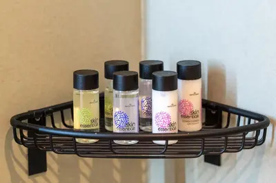 a rack with four bottles of cosmetics on a wall at Piraeus Marina Haven 3 in Piraeus