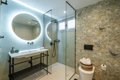 a bathroom with a shower and a sink and a mirror at Piraeus Marina Haven 3 in Piraeus