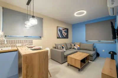 a living room with a couch and a table at Multi-Unit Apartment Piraeus - For Large Groups in Piraeus