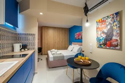 a bedroom with a bed and a table in a room at Multi-Unit Apartment Piraeus - For Large Groups in Piraeus