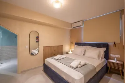 a bedroom with a large bed and a bath tub at Multi-Unit Apartment Piraeus - For Large Groups in Piraeus
