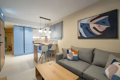 a living room with a couch and a table at Multi-Unit Apartment Piraeus - For Large Groups in Piraeus