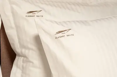 a white shirt with two birds on the back of it at Multi-Unit Apartment Piraeus - For Large Groups in Piraeus