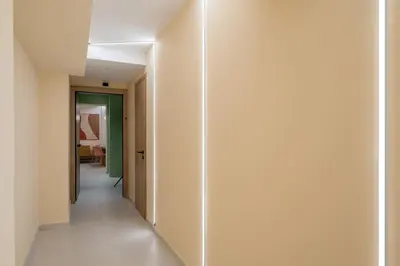 a hallway with white walls and a white floor at Multi-Unit Apartment Piraeus - For Large Groups in Piraeus