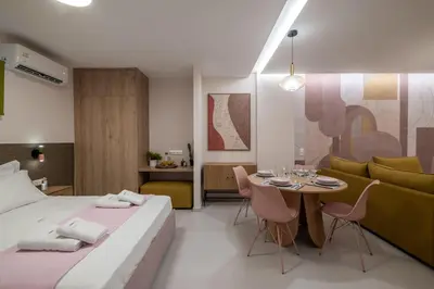 a bedroom with a bed and a table and a couch at Multi-Unit Apartment Piraeus - For Large Groups in Piraeus