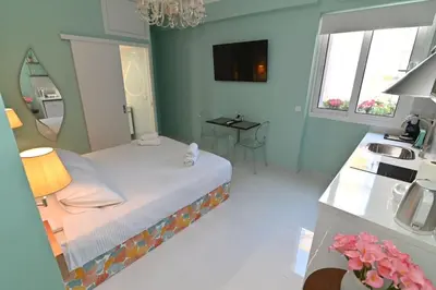 a bedroom with a bed and a sink in it at Warm & cozy studio - apartment 1 in Athens