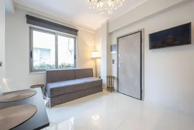 a living room with a couch and a window at Warm & cozy studio - apartment! #9 in Athens