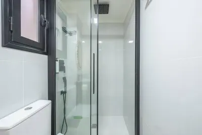 a shower with a glass door in a bathroom at Warm & cozy studio - apartment! #9 in Athens
