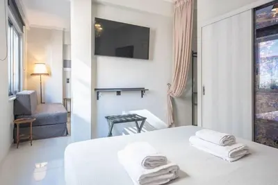 a white room with a bed with towels on it at Warm & cozy studio - apartment! #9 in Athens