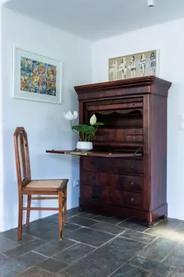 a wooden organ and a chair in a room at Danae's Art in Athens