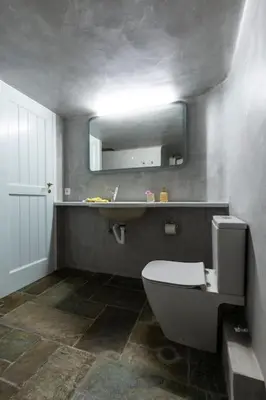 a bathroom with a toilet and a sink and a mirror at Danae's Art in Athens