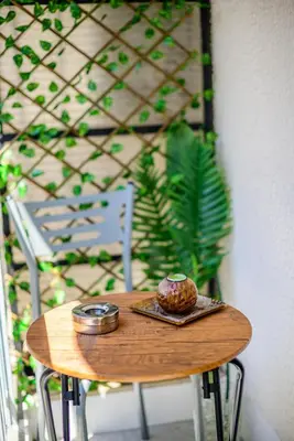 a small wooden table with a muffin on it at Ser House in Athens
