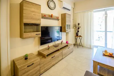 a living room with a flat screen tv on the wall at Ser House in Athens