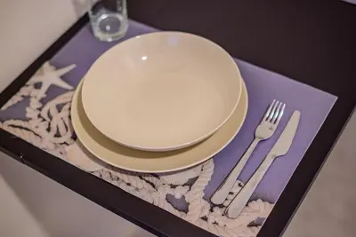 a plate and fork and knife on a table at Ser House in Athens