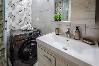 a bathroom with a washing machine and a sink at Ser House in Athens