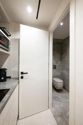 a white door in a kitchen with a toilet at Fiftyone Deluxe Studio in Athens