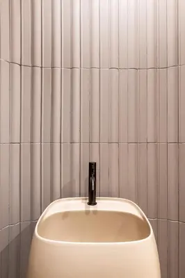 a white urinal with a faucet in a bathroom at Fiftyone Deluxe Studio in Athens