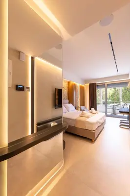 a hotel room with two beds and a balcony at Fiftyone Deluxe Studio in Athens