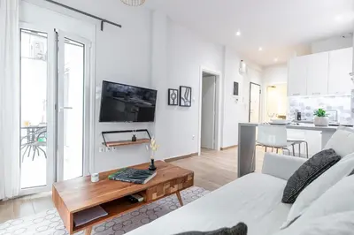 a living room with a couch and a coffee table at Zeus 1 bdr apartment in Koukaki in Athens