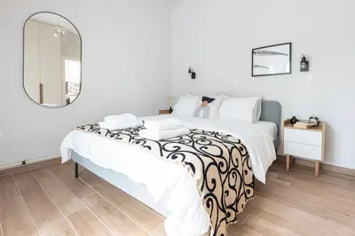 a bedroom with a bed and a mirror at Zeus 1 bdr apartment in Koukaki in Athens