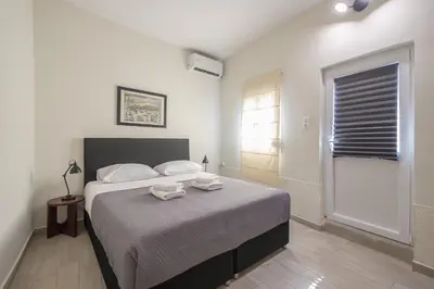 a bedroom with a bed with two towels on it at Petralona Gem with Private Terrace in Athens
