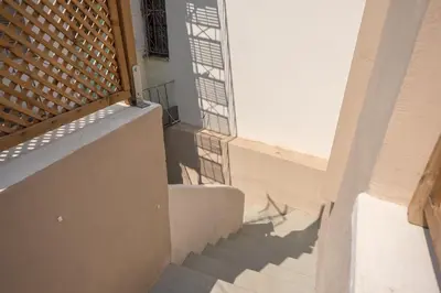a staircase leading up to a building with a window at Petralona Gem with Private Terrace in Athens