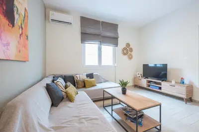 a living room with a couch and a tv at Petralona Gem with Private Terrace in Athens