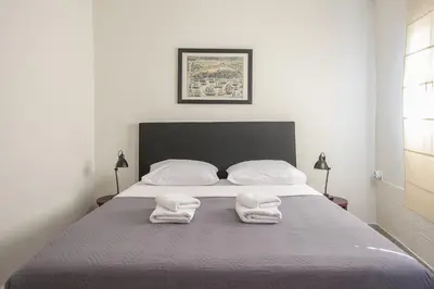 a bedroom with a bed with two towels on it at Petralona Gem with Private Terrace in Athens