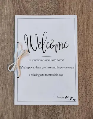 a white welcome card with a welcome message at Alexandra 's Home in Athens