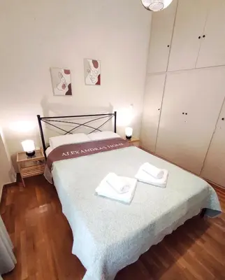 a bedroom with a bed with two towels on it at Alexandra 's Home in Athens