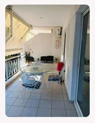 a balcony with a table and chairs in a room at Artemis sea house in Porto Rafti