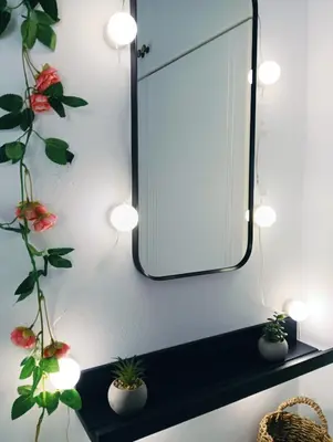 a mirror on a wall with potted plants on a shelf at Artemis sea house in Porto Rafti
