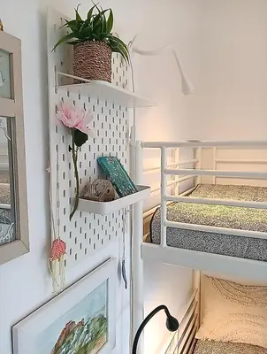 a room with white shelves and a flower on a wall at Artemis sea house in Porto Rafti
